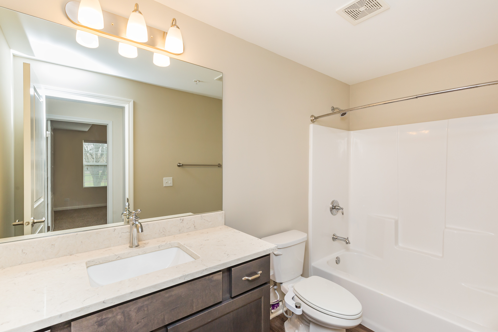 60 West Main Street, Unit 233 Lake Zurich, IL 60047 - Photo 12 of 15 a bathroom with a sink a toilet a mirror and shower