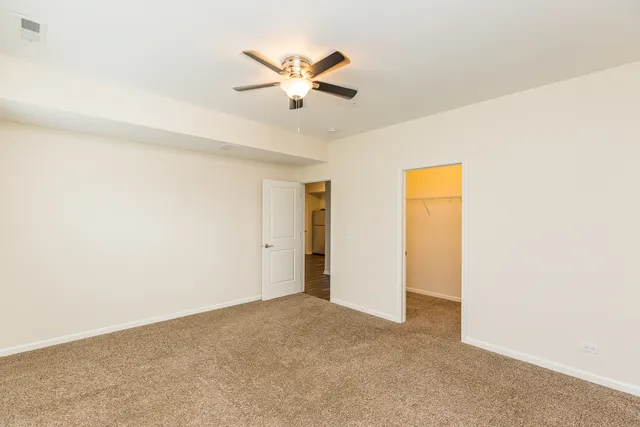 a view of a livingroom with a ceiling fan and wooden floor