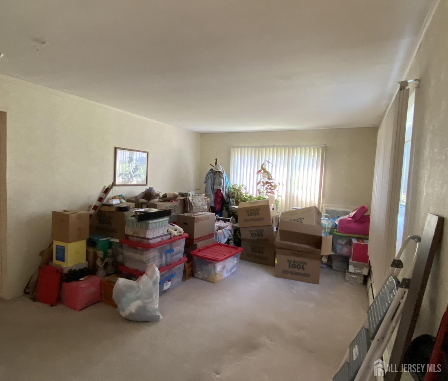 2 Avon Road Edison, NJ 08817 - Photo 10 of 11 a living room filled with furniture and a window