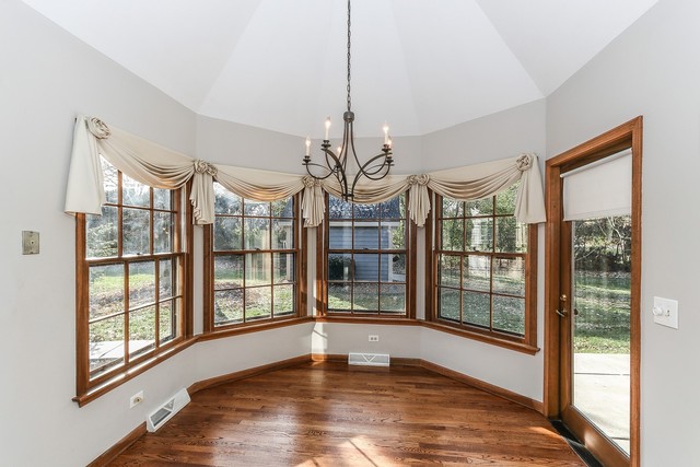 102 Wilcox Drive Bartlett, IL 60103 - Photo 12 of 30 a view of an empty room with wooden floor and a window
