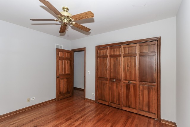 102 Wilcox Drive Bartlett, IL 60103 - Photo 20 of 30 an empty room with wooden floor closet and windows