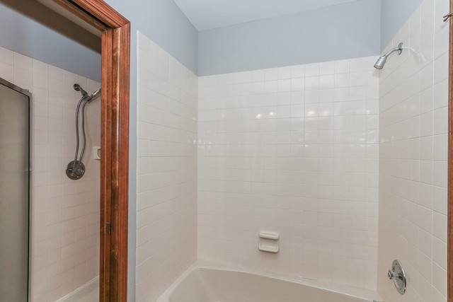 102 Wilcox Drive Bartlett, IL 60103 - Photo 22 of 30 a bathroom with a shower and a tub