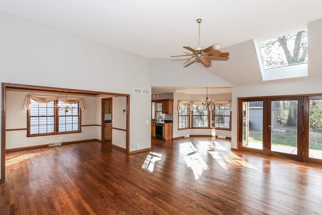 102 Wilcox Drive Bartlett, IL 60103 - Photo 5 of 30 a view of an empty room with wooden floor and a window