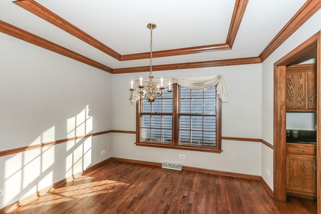 102 Wilcox Drive Bartlett, IL 60103 - Photo 6 of 30 a view of an empty room with wooden floor and a window