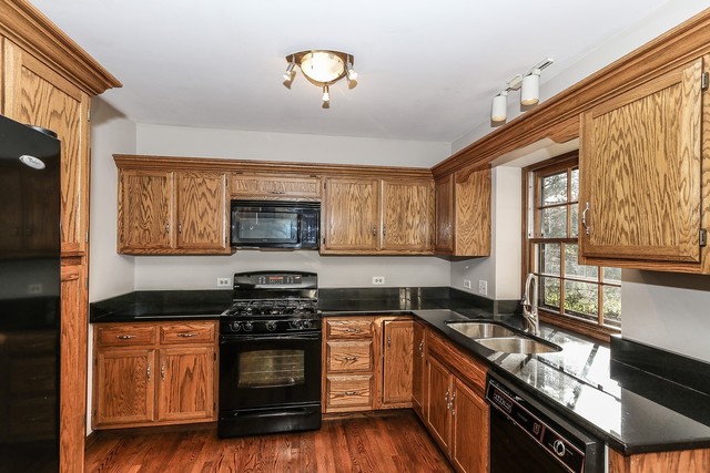 102 Wilcox Drive Bartlett, IL 60103 - Photo 8 of 30 a kitchen with a stove and a microwave