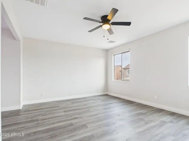a view of a room with wooden floor and a window