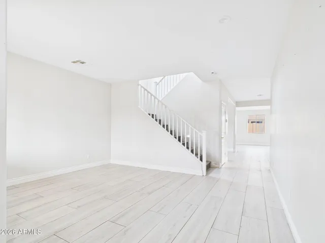 a view of a room with wooden floor
