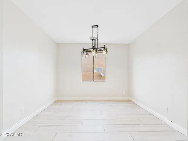 a large kitchen with a refrigerator a sink and a window