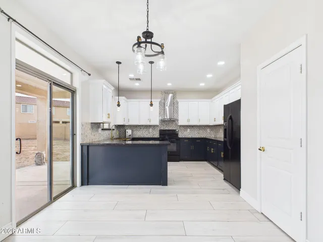 a kitchen with stainless steel appliances granite countertop a sink a stove and cabinets