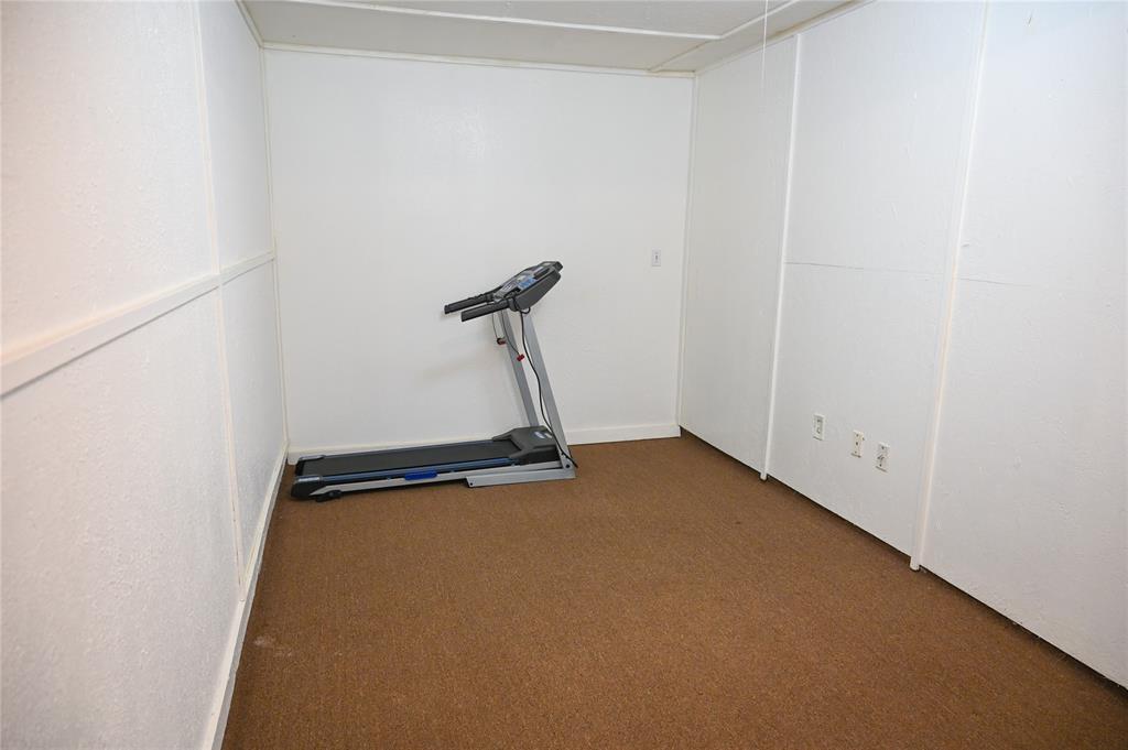 1352 Simpson Drive Hurst, TX 76053 - Photo 26 of 40 Room featuring textured white paneling and a brown carpeted floor