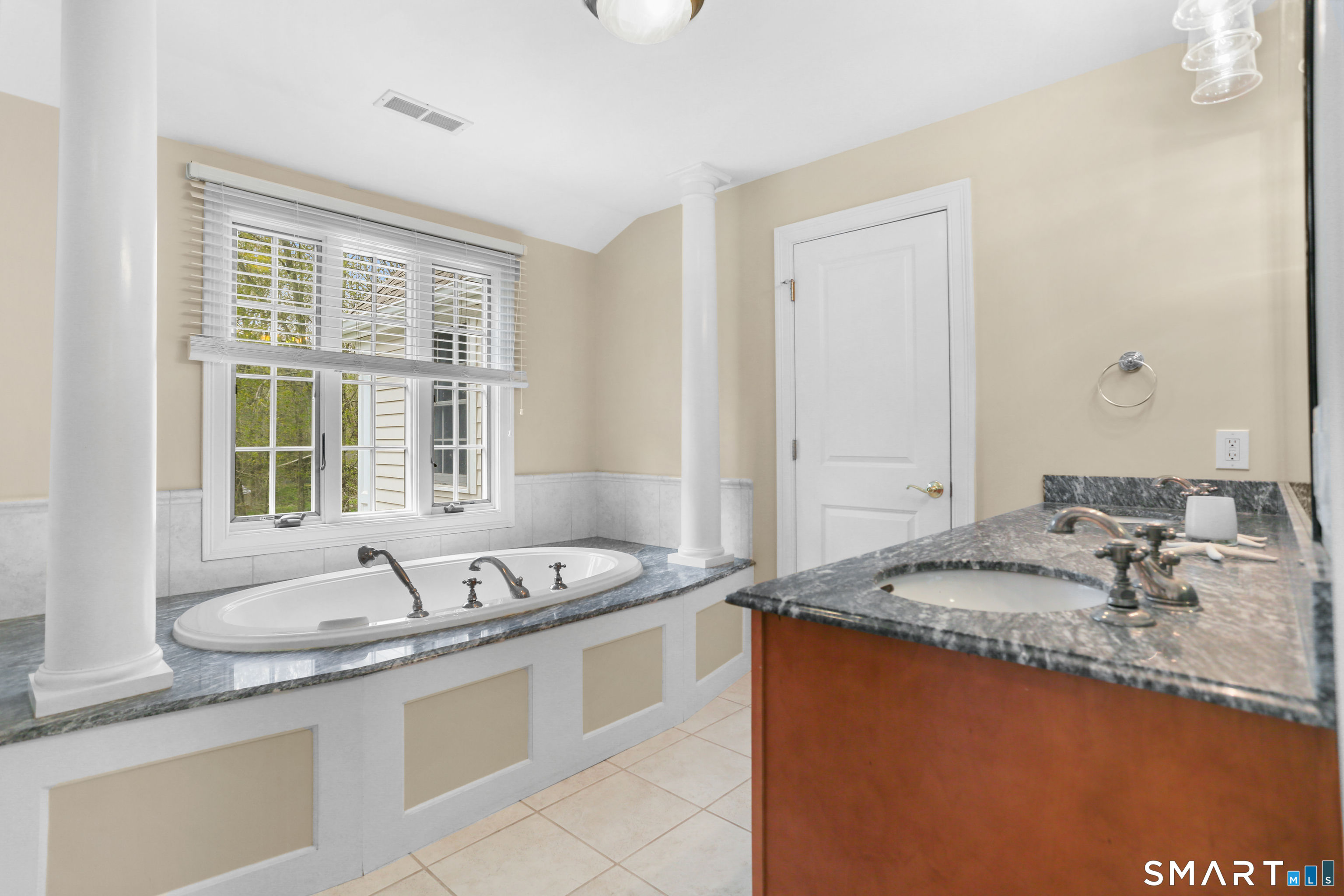 4041 Redding Road Fairfield, CT 06824 - Photo 21 of 33 a bath room with a sink granite and a mirror