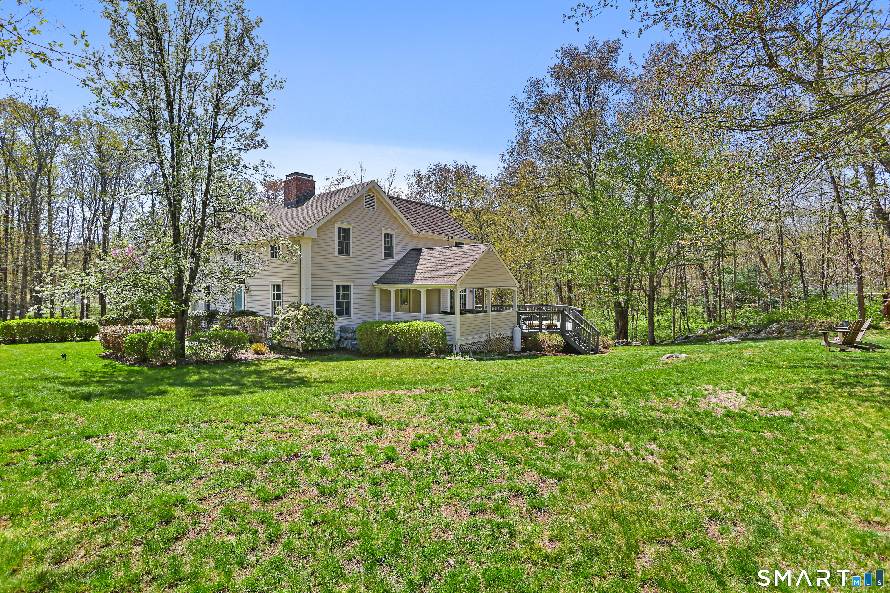 4041 Redding Road Fairfield, CT 06824 - Photo 33 of 33 a front view of a house with a yard and trees