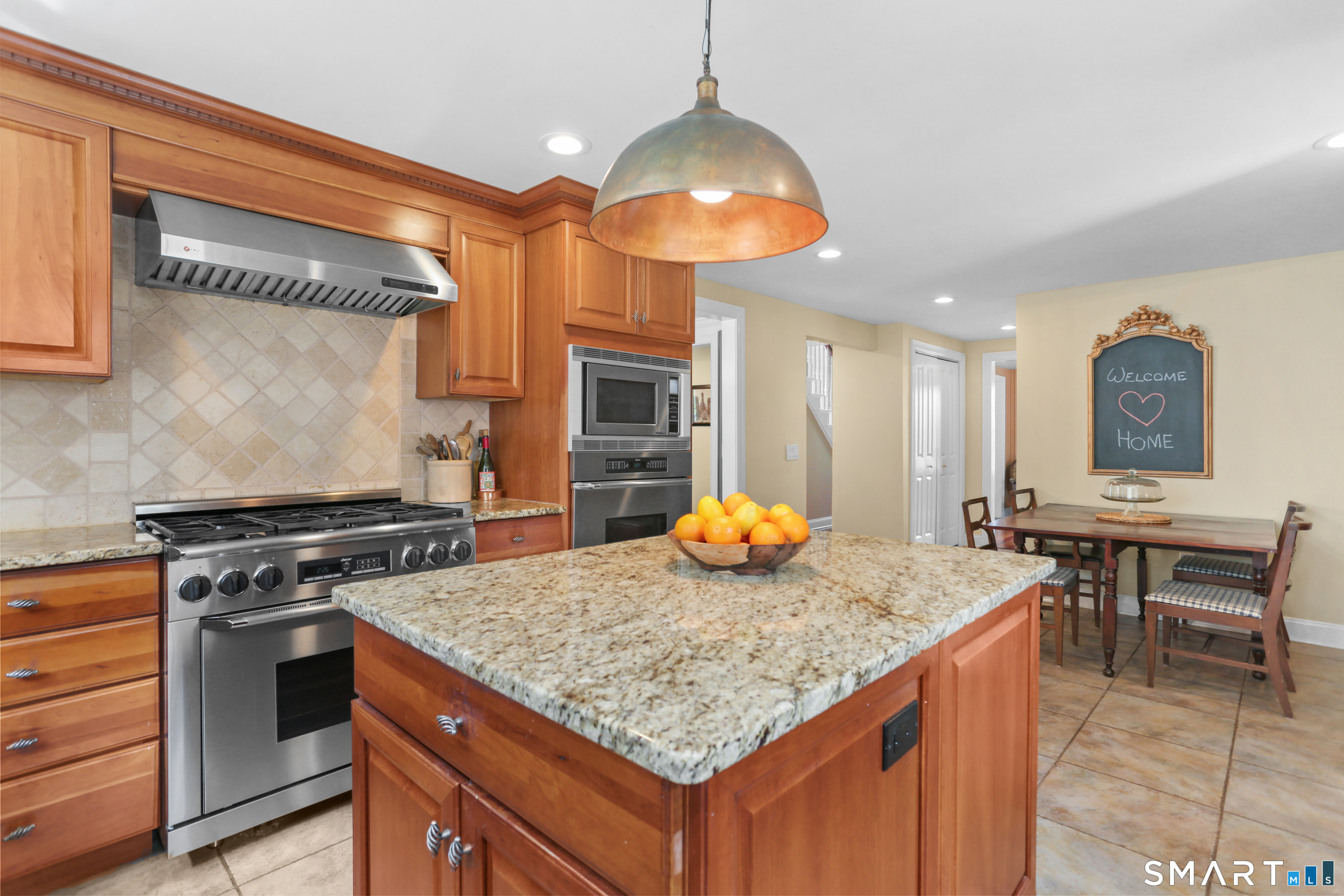 4041 Redding Road Fairfield, CT 06824 - Photo 9 of 33 a kitchen with a stove and a table