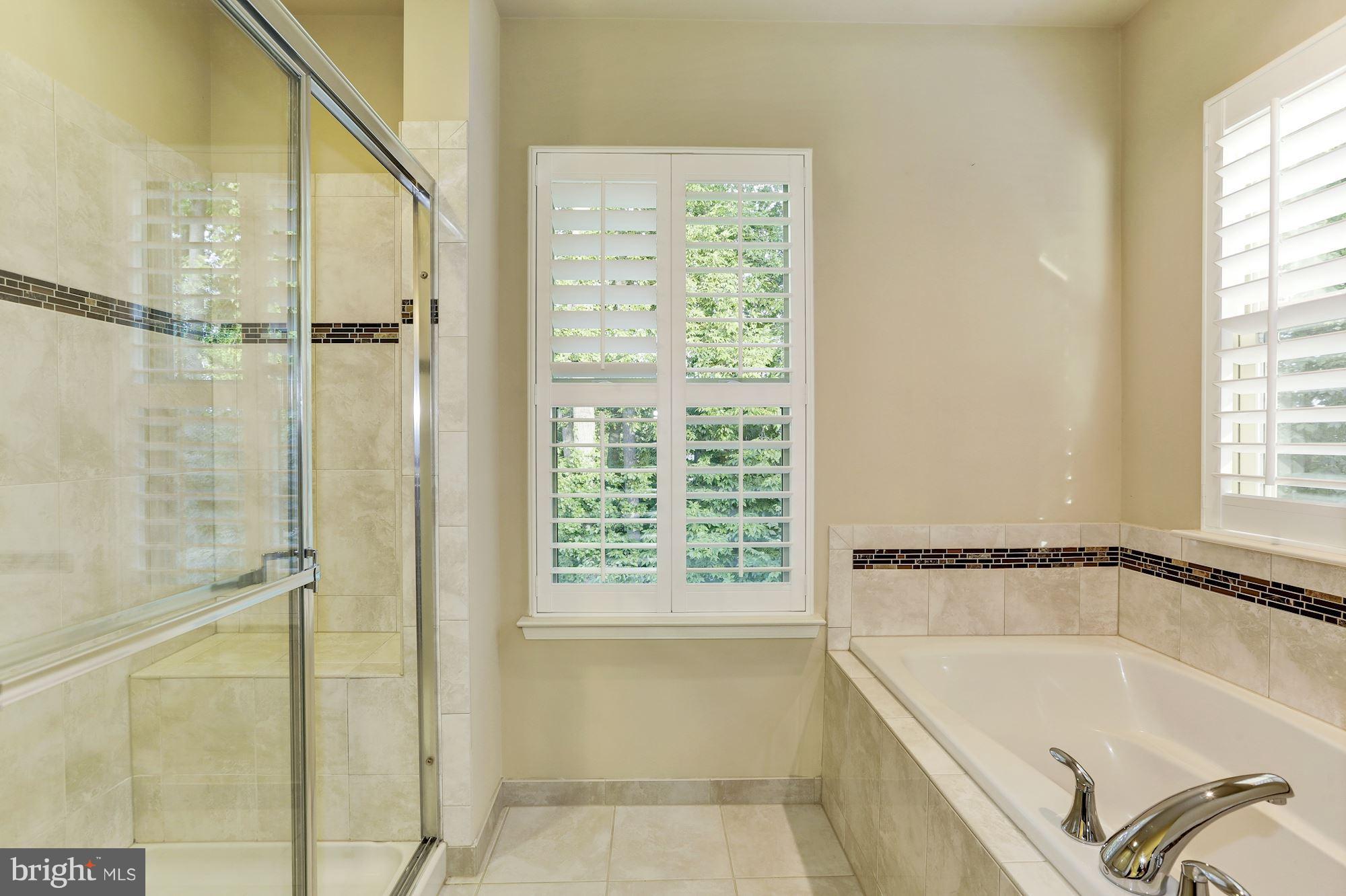 14405 Vedanta Way Silver Spring, MD 20906 - Photo 17 of 30 Bath with soaking tub, decorative tile, shutters