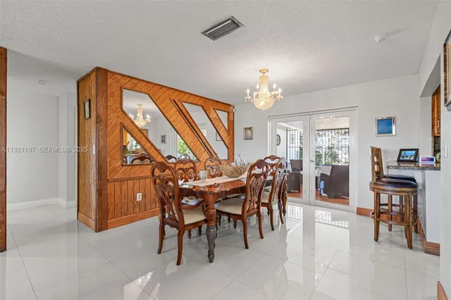 a view of a dining room with furniture and chandelier