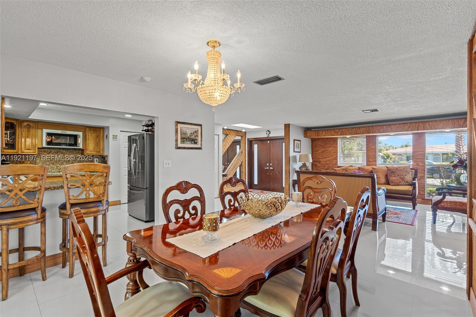 7004 Southwest 139th Place Miami, FL 33183 - Photo 14 of 54 a view of a dining room with furniture and chandelier