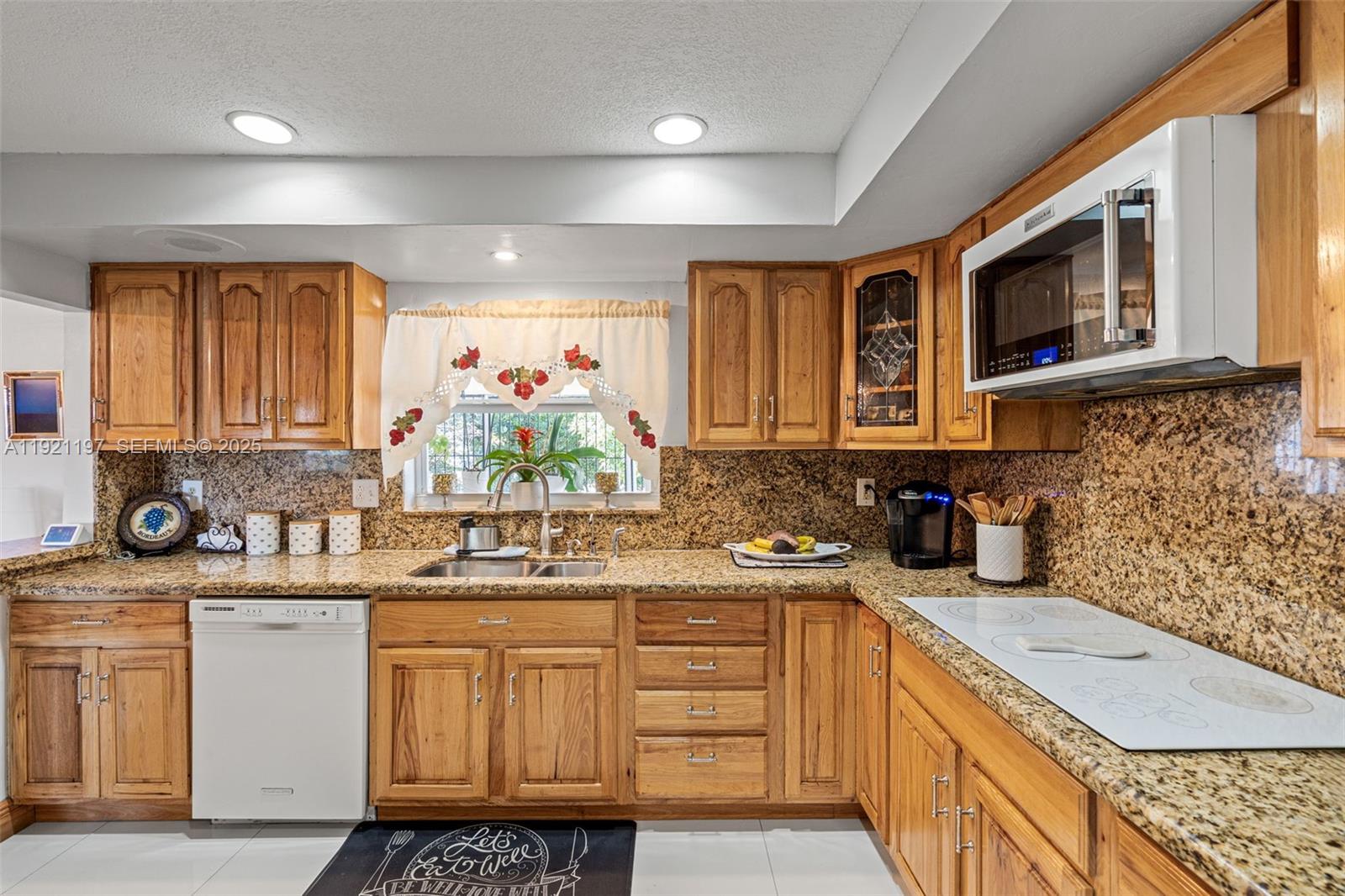 7004 Southwest 139th Place Miami, FL 33183 - Photo 17 of 54 a kitchen with a sink stove top oven and cabinets