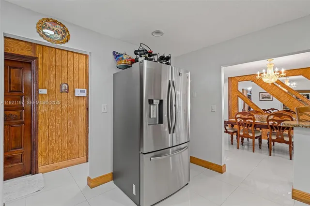a kitchen with granite countertop a refrigerator and a sink