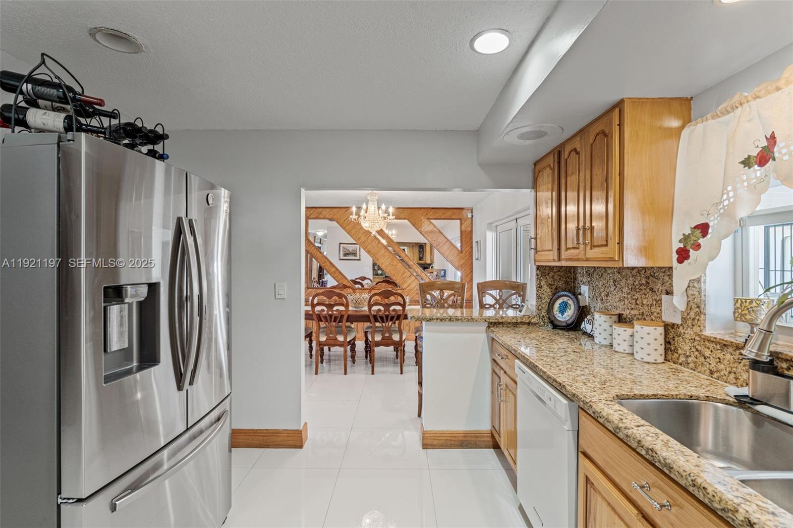 7004 Southwest 139th Place Miami, FL 33183 - Photo 19 of 54 a kitchen with granite countertop a refrigerator and a sink