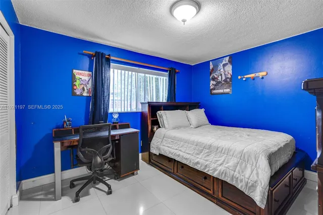 a bedroom with a bed and a television