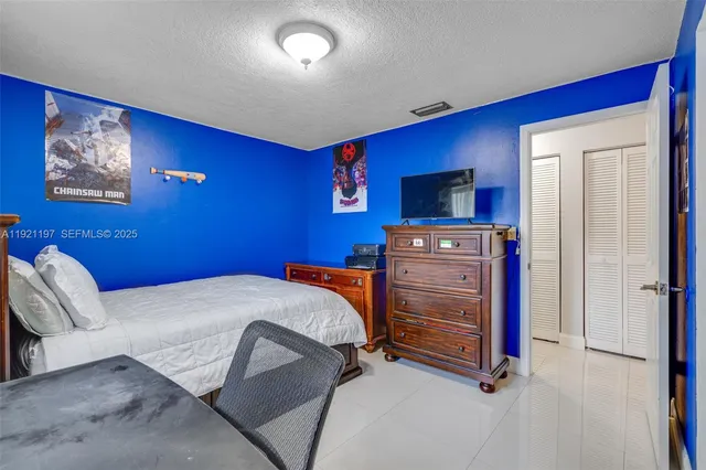 a bedroom with a large bed and a dresser