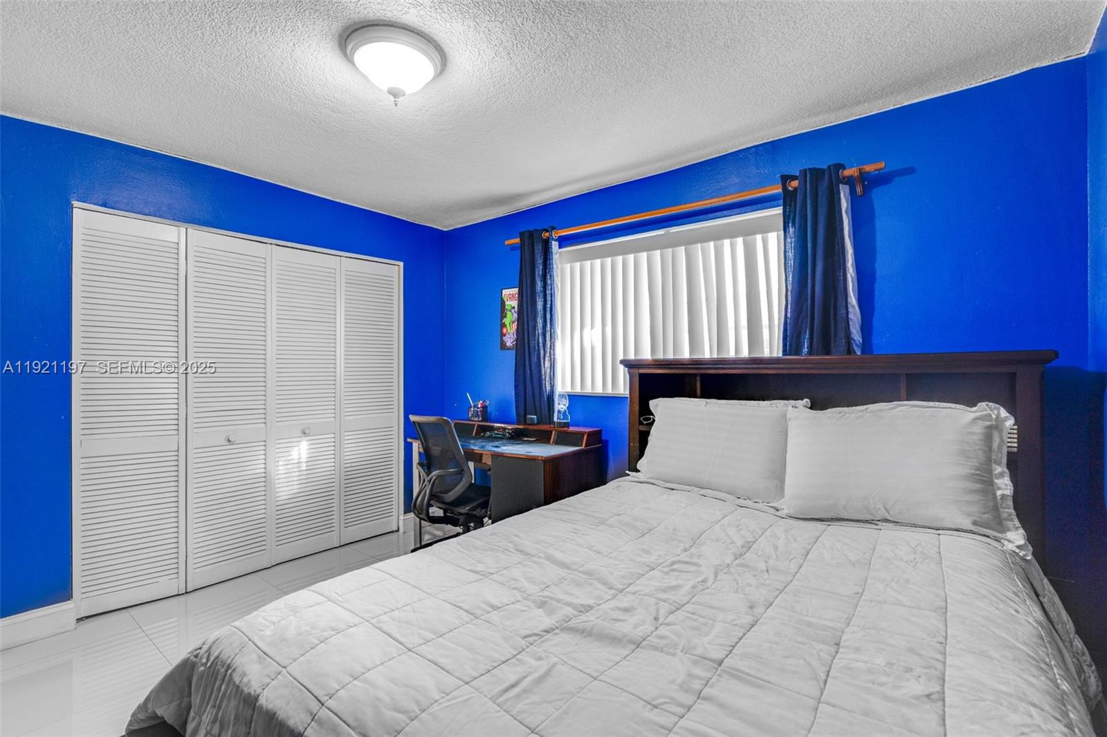 7004 Southwest 139th Place Miami, FL 33183 - Photo 25 of 54 a bedroom with a large bed and a dresser