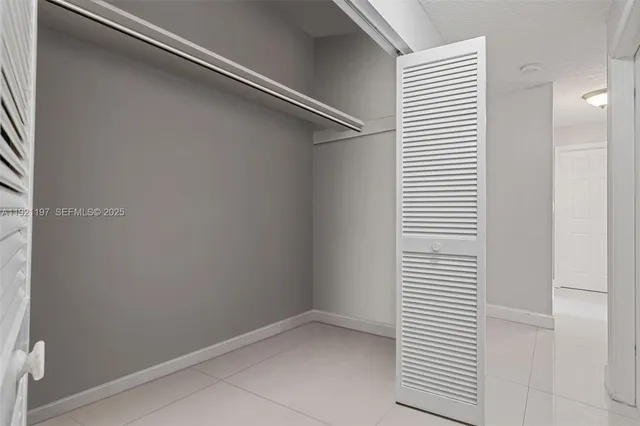 a bedroom with a bed and a television