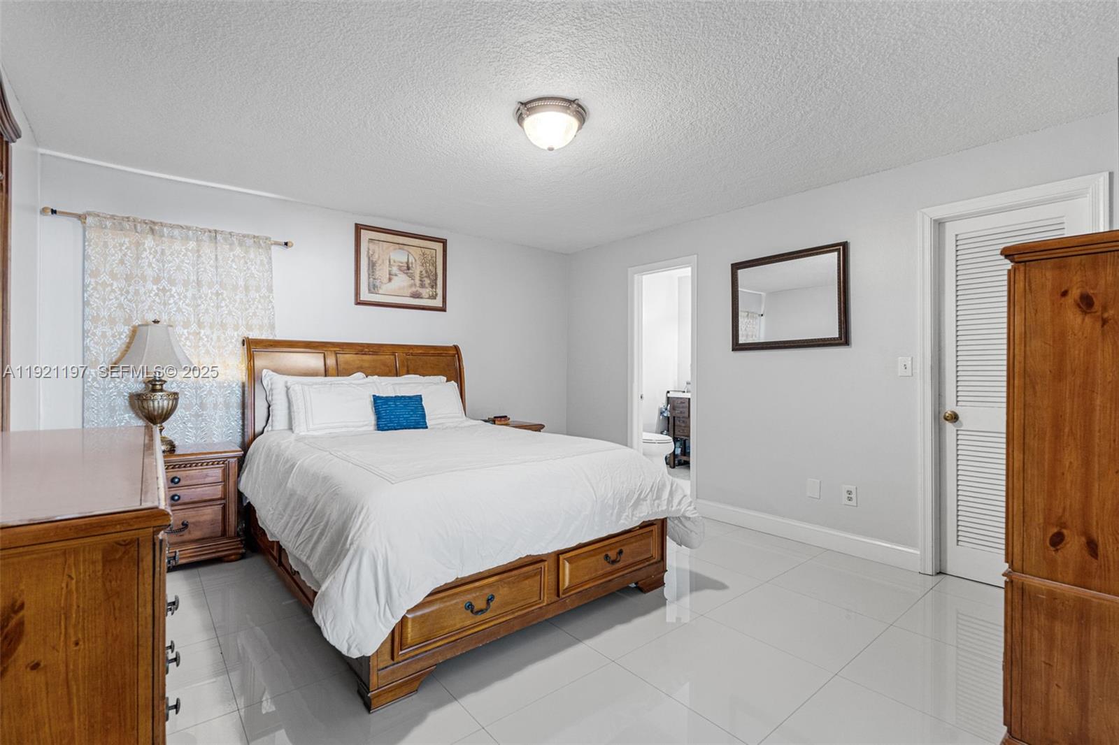 7004 Southwest 139th Place Miami, FL 33183 - Photo 27 of 54 a bedroom with a bed and a night stand