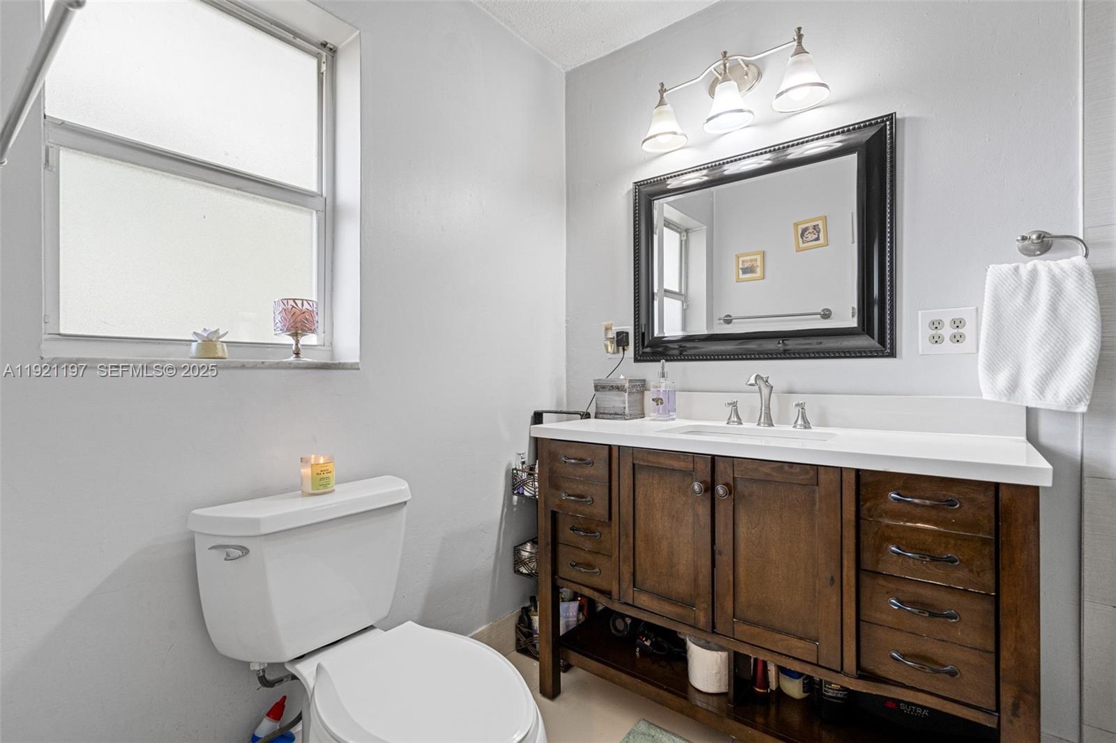 7004 Southwest 139th Place Miami, FL 33183 - Photo 29 of 54 a bathroom with a toilet sink and mirror