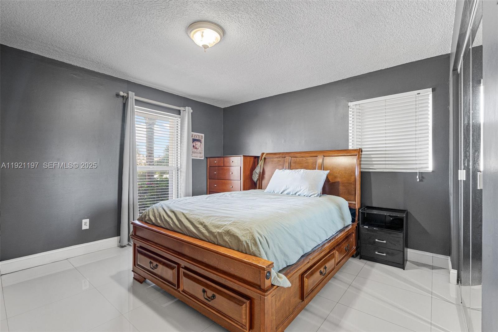 7004 Southwest 139th Place Miami, FL 33183 - Photo 32 of 54 a bed sitting in a bedroom next to a window