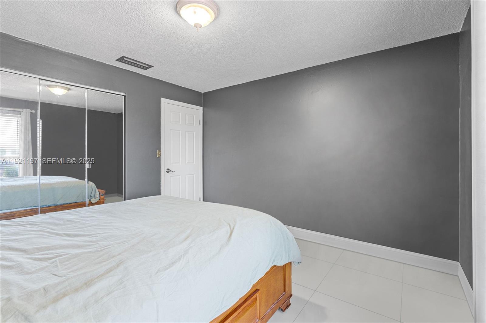 7004 Southwest 139th Place Miami, FL 33183 - Photo 33 of 54 a bedroom with a bed and a lamp