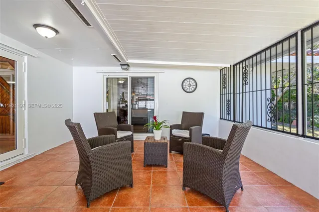 a dining room with furniture wooden floor and a potted plant