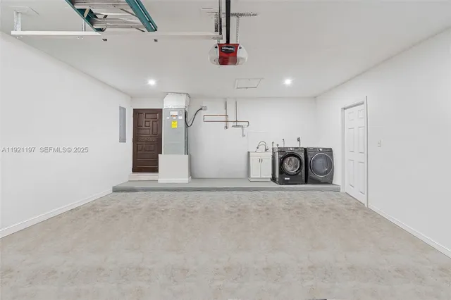 a view of a yard with plants and large trees