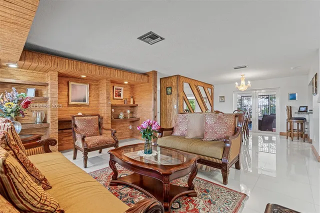 a living room with furniture a rug and a table