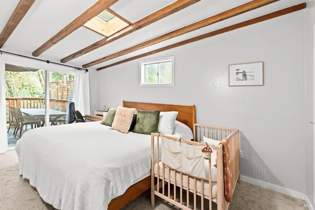 a bed sitting in a bedroom next to a window