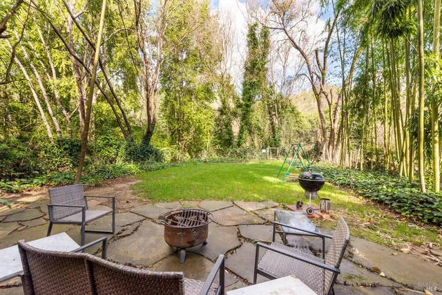 a view of yard with seating area and trees