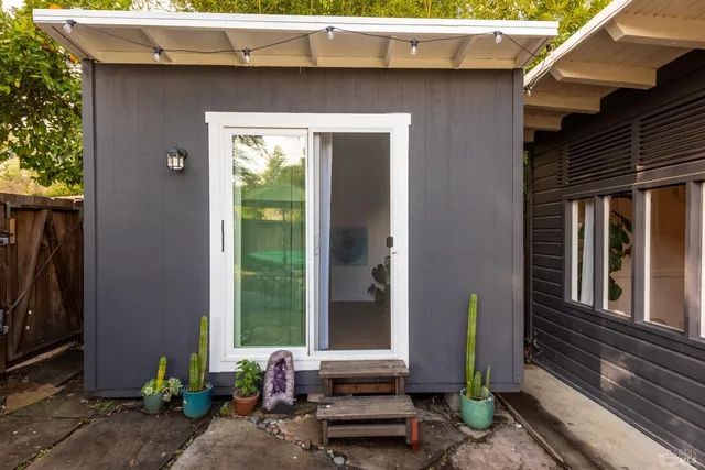 a view of a workspace with furniture and a potted plant