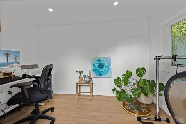 a view of a table and chairs under an umbrella in backyard
