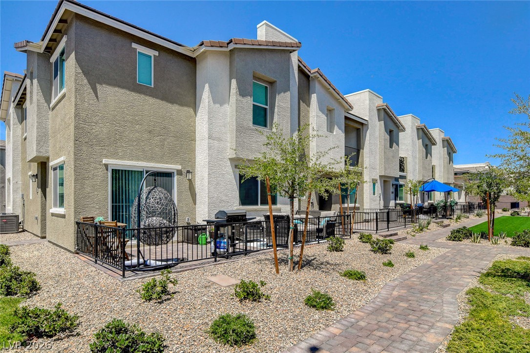 6924 Spicy Merlot Street North Las Vegas, NV 89086 - Photo 63 of 83 A private patio space, perfect for outdoor dining and relaxation, complements this multi-level residence.