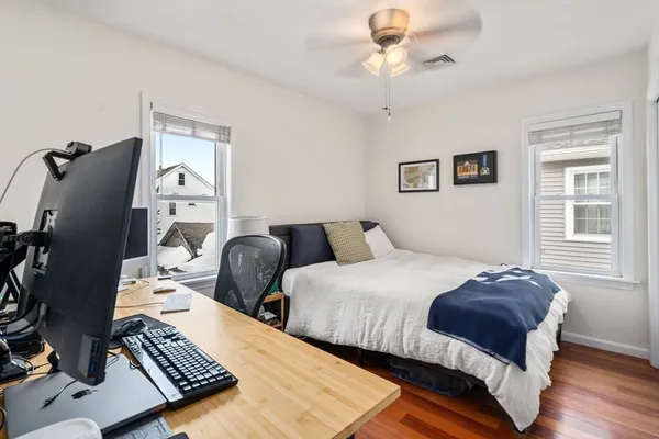 a bedroom with two beds and a window