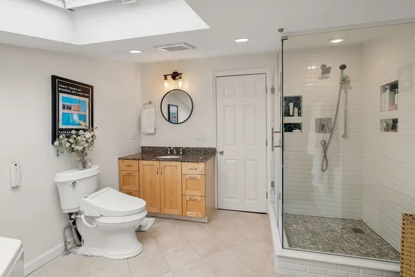 a bathroom with a toilet a sink and a shower