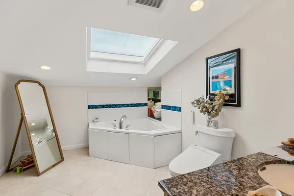 a bathroom with a sink toilet and a mirror