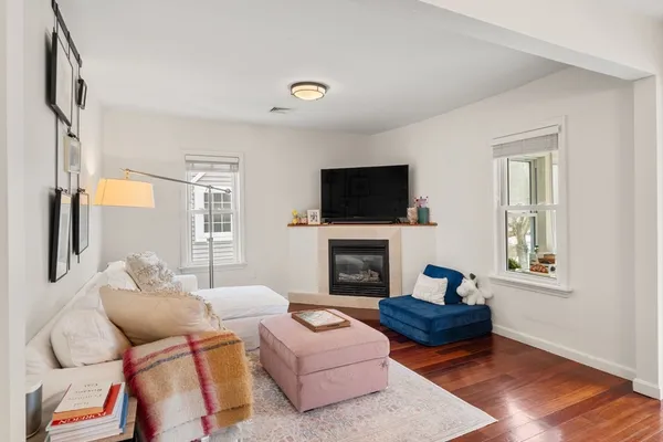 a living room with furniture fireplace and a window