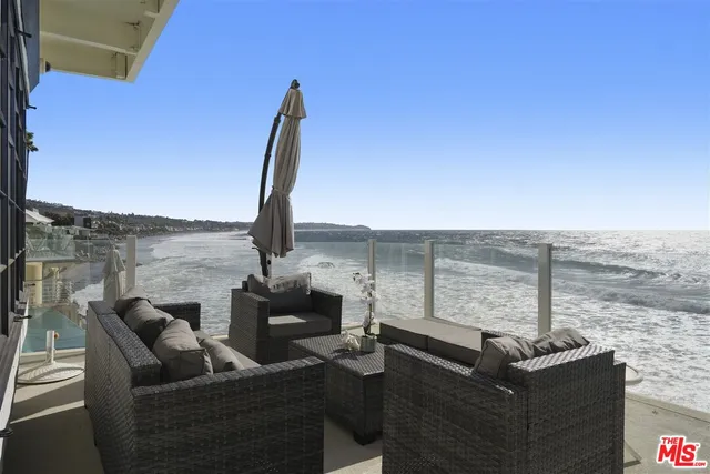 a view of a terrace with couches and sky view