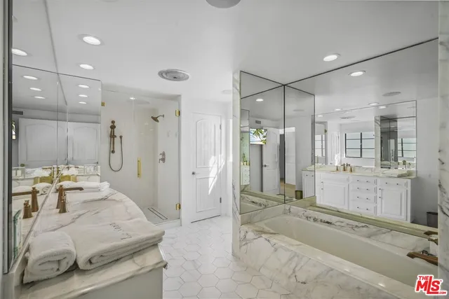 a bathroom with a sink a vanity and a bathtub