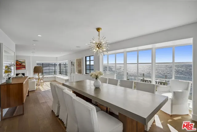 a kitchen with stainless steel appliances granite countertop a sink counter space and living room view
