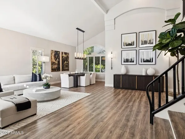 a living room with furniture and wooden floor