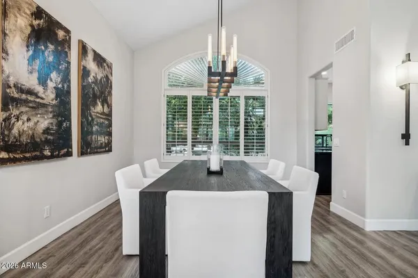 a kitchen with kitchen island a counter top space a sink stainless steel appliances and cabinets