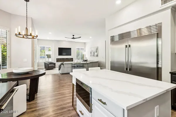 a kitchen with stainless steel appliances granite countertop a stove a sink and a refrigerator