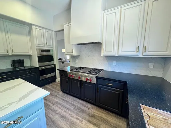 a kitchen with a sink cabinets and a stove